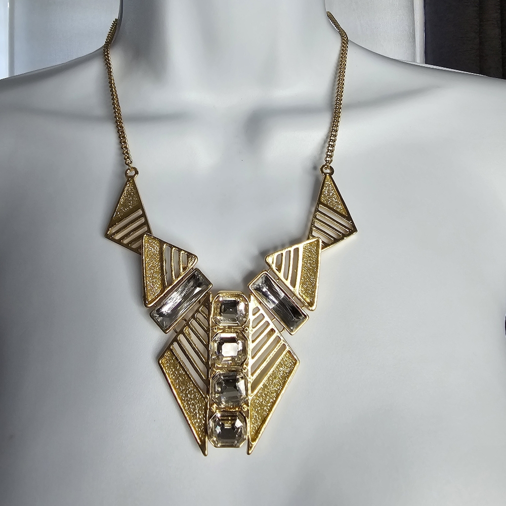 Gold metal statement necklace features geometric triangular motifs NY&Co